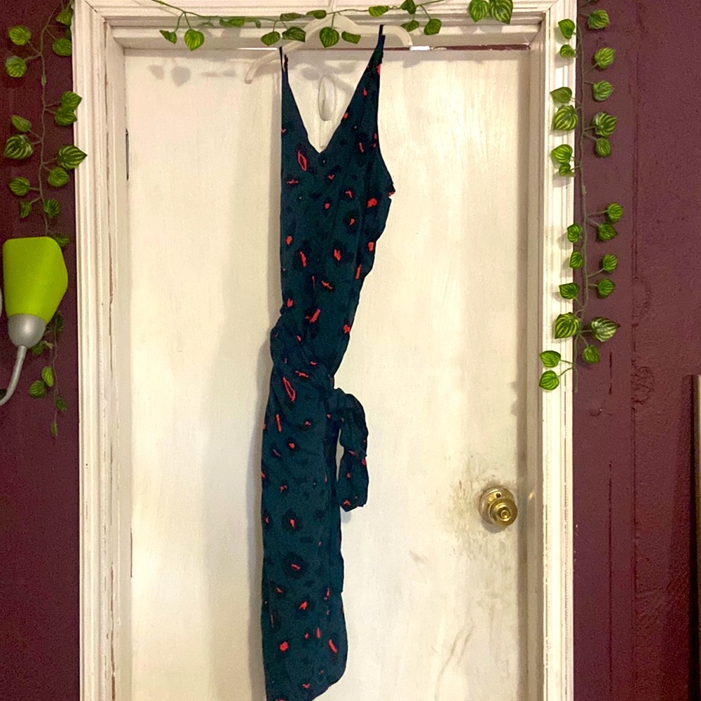 Teal wrap dress with fall color vibes would look cute with long heel boots .